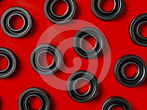 High Contrast Red Background with Black Rubber Seals in Symmetrical Pattern Industrial and Mechanical Concept Photography