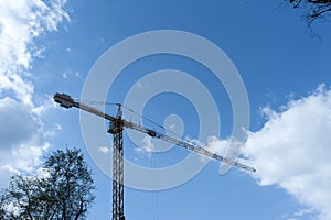 High crane in the cloudy sky