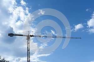 High crane in the cloudy sky