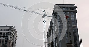 High crane works on construction site. Skyscraper with crane. Workers working on the construction site. Builders build a house. Hi