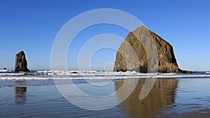 High definition 1080p zooming out movie of beautiful Cannon Beach with its well-known Haystack Rock landmark and Needles located n