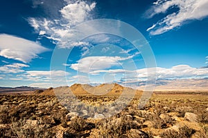 High desert landscape to distant hills with OHV dirt track photo