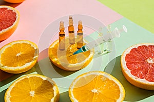 High dose vitamin C, ampule for injection with syringe and fresh juicy orange fruit slides. Concept of vitamin,mineral