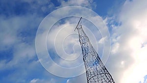 High electrical tower, cell tower on cloudy sky