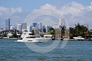 High-end cabin cruiser against a Miami tall building skyline.
