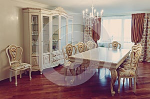 High-end luxury furniture. Interior of modern living room furniture in classic style. white tree with gold trim. patina. carving.