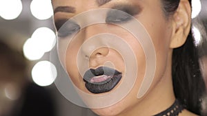 High Fashion Beauty Model Girl with Black Make up and Long Lushes. Black Lips.