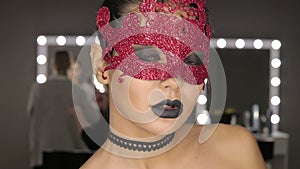 High fashion beauty model girl with black make up and long lushes. Black Lips.