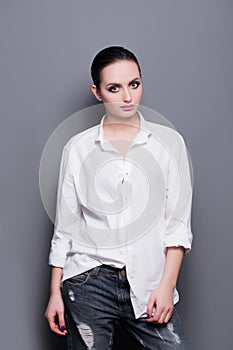 High fashion look glamor portrait of beautiful sexy stylish Caucasian young woman model in a white shirt. Professional Make up for