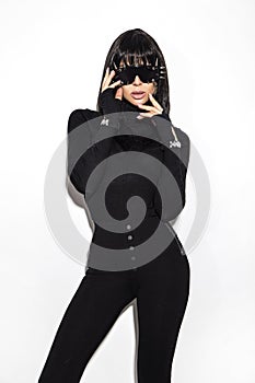 High fashion look. Glamour stylish beautiful young model in black clothing isolated on white background. Beauty stylish brunette