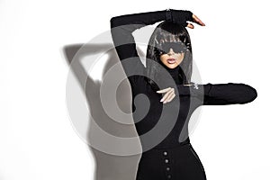 High fashion look. Glamour stylish beautiful young model in black clothing isolated on white background. Beauty stylish brunette