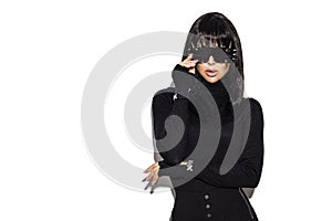 High fashion look. Glamour stylish beautiful young model in black clothing isolated on white background. Beauty stylish brunette