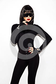 High fashion look. Glamour stylish beautiful young model in black clothing isolated on white background. Beauty stylish brunette