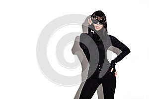 High fashion look. Glamour stylish beautiful young model in black clothing isolated on white background. Beauty stylish brunette