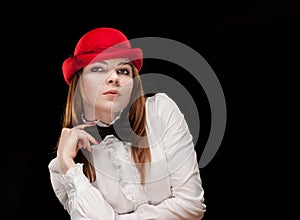 High fashion look. portrait of beautiful sexy young female woman with red lips on black background with hat