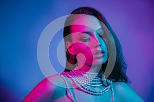 High Fashion model in colorful bright neon lights posing at studio