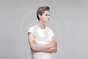 High Fashion model man portrait isolated on grey background. Handsome guy closeup
