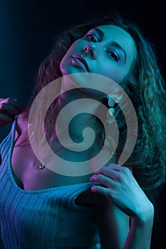 High Fashion model woman in colorful bright lights posing, portrait of a beautiful girl. Artistic colorful design. Party concept