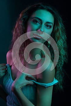 High Fashion model woman in colorful bright lights posing, portrait of a beautiful girl. Artistic colorful design. Party concept