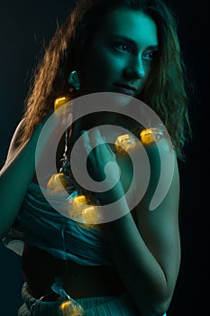 High Fashion model woman in colorful bright lights posing, portrait of a beautiful girl. Artistic colorful design. Party concept