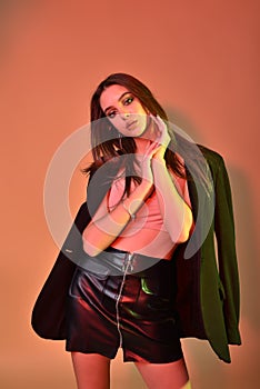High Fashion model woman in colorful bright lights posing in studio, portrait of beautiful sexy girl
