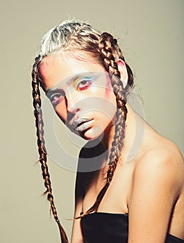 High Fashion model woman with colorful bright makeup posing in studio, portrait of beautiful girl with trendy make-up