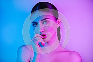 High Fashion woman in colorful bright neon uv blue and purple lights, posing in studio