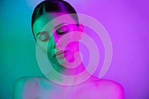 High Fashion woman in colorful bright neon uv blue and purple lights, posing in studio