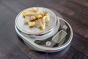 High fat low carb healthy snack - pork rinds measured on kitchen scale