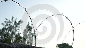 High fence with barbed wire, secret governmental object, correctional facility