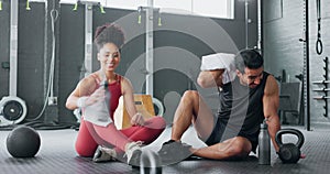 High five, fitness and happy man and women water drink after training workout in gym together. Healthy sports coach