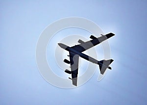 High flying United States Air Force Boeing B-52 Stratofortress in silhouette.