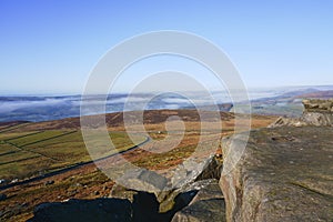 High on the gritstone rocks of Stanage Edge in the Derbyshire Peak District
