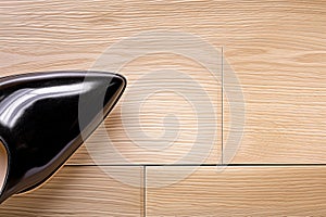 high heel shoe on a solid engineered wood sample, checking durability