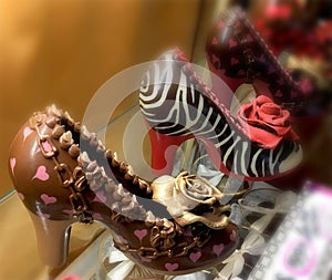 High-heeled shoes made of chocolate in shop window display