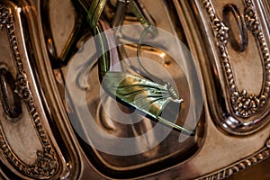 HIgh heels sit on an antique silver tray