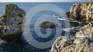 High inaccessible coastal cliffs made of shell rock near the village of Tyulenovo, southern Bulgaria