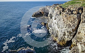 High inaccessible coastal cliffs made of shell rock near the village of Tyulenovo, southern Bulgaria