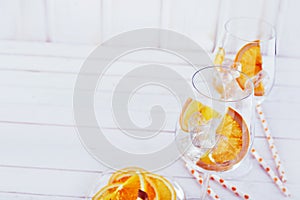 High key cocktail wine glasses and sliced orange
