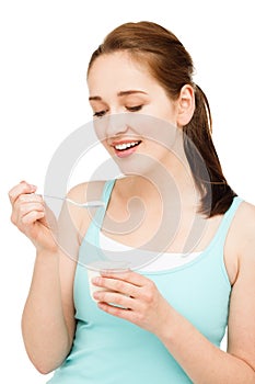 High key Portrait young caucasian woman eating yogurt isolated