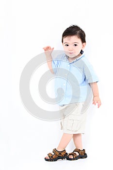 High Key Toddler Boy Standing Against White Wall photo