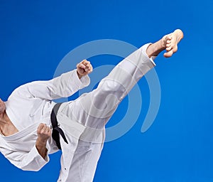 High kick athlete is beating with a black belt