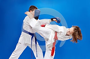High kick leg and punch arm athletes are beating with overlays on hands