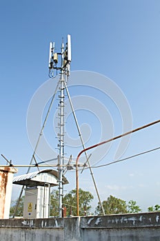 High mast metal structure telecommunication on tower with blue sky.