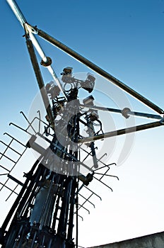 High mast metal structure telecommunication on tower with blue sky.