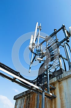 High mast metal structure telecommunication on tower with blue sky.