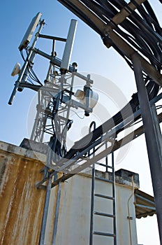 High mast metal structure telecommunication on tower with blue sky.