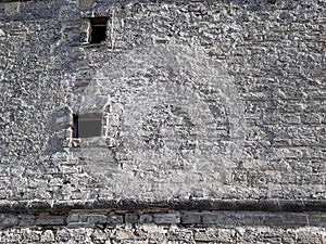 High medieval stone castle wall with two windows