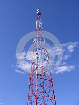 High metal radio tower powerful transmitter on blue sky background