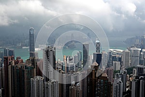 High modern buildings in fog and thick rain clouds of Hong Kong harbor from view point